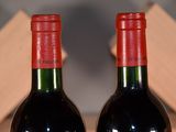two bottles of wine that are sitting on a table