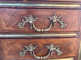 an antique chest of drawers with ornate handles and brass hardware