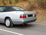 a silver car that is driving down the street