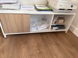 a desk with a printer, printer and other office supplies on it