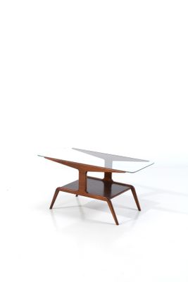 an image of a coffee table with a glass top and wooden legs