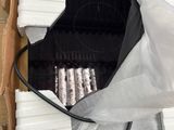 a box with a bunch of white candles inside of it