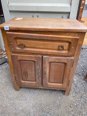 a wooden cabinet with two drawers on top of it