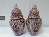 two vases that are sitting on a table