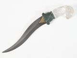a knife that is laying on a white surface