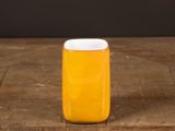 a jar of orange juice sitting on a wooden table