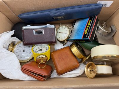 a box full of assorted items including a watch, wallet, watch case and other items