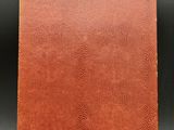 a brown leather journal with a gold clasp