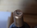 two bottles of wine sitting next to each other on a table