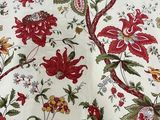 a red and green floral pattern on a white table cloth