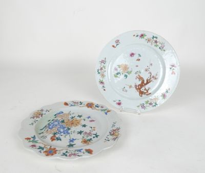 two plates with floral designs on them sitting next to each other