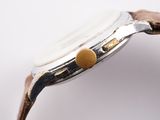 an image of a close up of a watch on a white surface