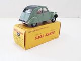 a green toy car sitting on top of a yellow box