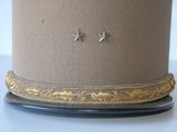 a close up of a hat with a pair of earrings on it