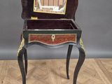 an old wooden table with a mirror on top of it