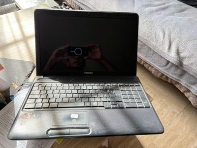 a laptop that is sitting on a table with a camera