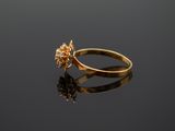 a close up of a gold ring on a black surface