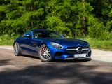a blue mercedes sports car parked on the side of the road