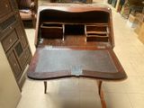 a wooden desk with a drawer on top of it