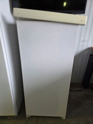 two white refrigerators in a room next to each other