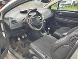 a car that is sitting in a lot with the door open