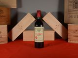 a bottle of wine sitting on a table next to wooden boxes