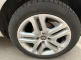 a close up of a tire on a white car