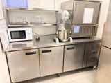 a kitchen with stainless steel cabinets and a mixer on the counter