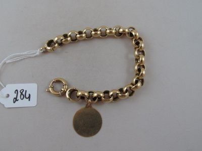 gold plated bracelet with a coin charm and a price tag