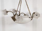 a chandelier hanging from the ceiling with flowers on it