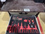 many tools in a tool box on the floor