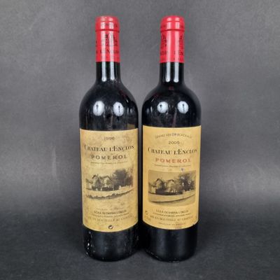 two bottles of red wine sitting next to each other on a table