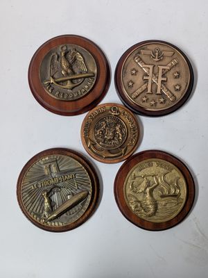 four different types of coins on a white surface