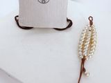 pearl and leather necklace and pouch on a white surface