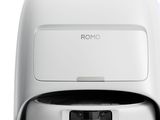 a close up of a white toilet with a remote control