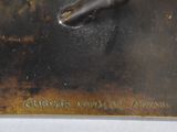 a bronze statue of a horse on a plate