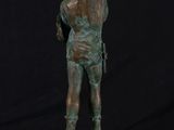 a bronze statue of a man standing on top of a marble base