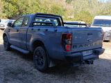 a blue pick up truck that is parked in a lot