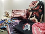 a pile of clothing and a backpack sitting on the floor