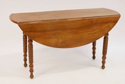 an old wooden table with turned legs on a white background