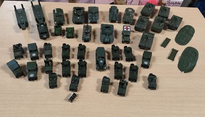 beaucoup de petits véhicules militaires miniatures posés sur une table