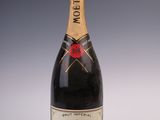 a close up of a bottle of champagne on a white surface