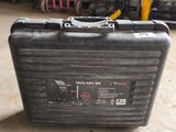 une valise noire posée par terre dans un garage