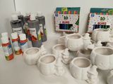 a lot of white pottery items on a table