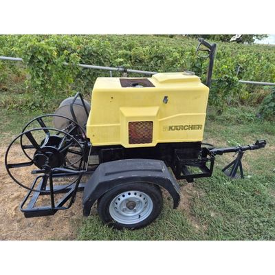 an image of a yellow machine is parked in the grass