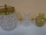 three glass vases sitting on a table next to each other