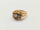 a close up of a gold ring with a diamond in the center