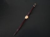 a close up of a wrist watch on a black surface
