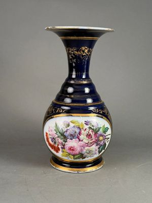 a blue vase with a floral design on it