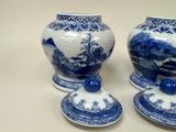 three blue and white vases sitting on a table